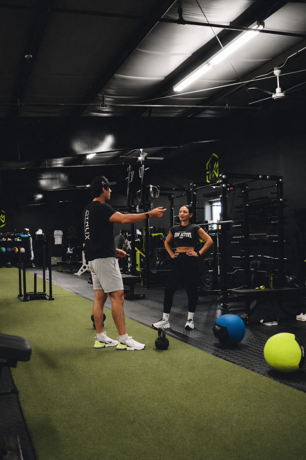 Coach guiding an athlete through a strength training set